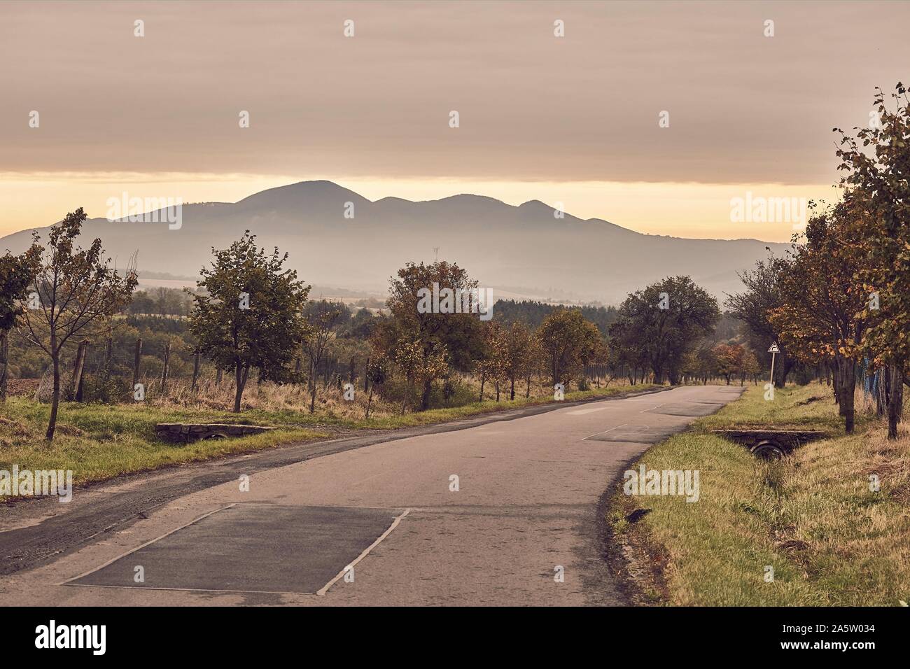 Autumn road through autumn landscape Stock Photo