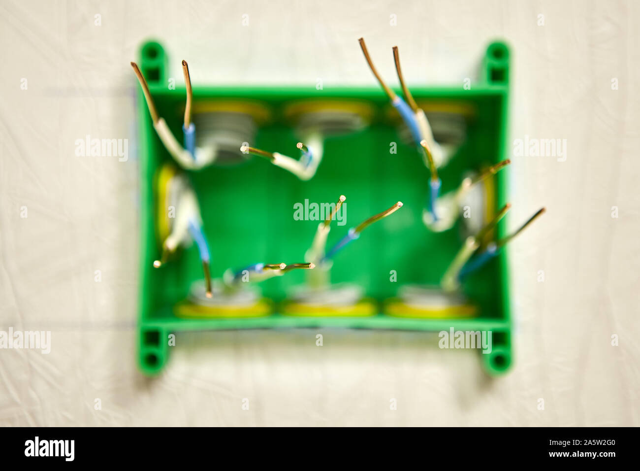 The ends of the bare copper wires are prepared for twisting into