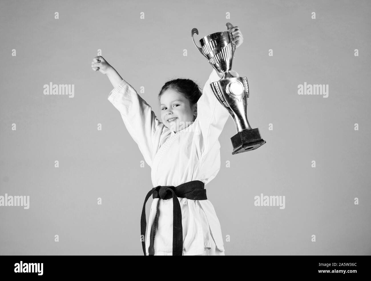 sport success. Training to be the best. small girl with champion cup