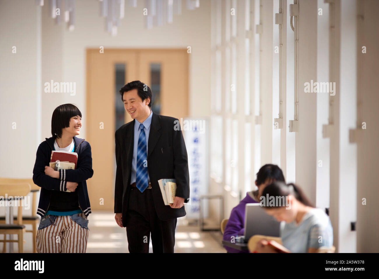Student talking teacher walking hi-res stock photography and images - Alamy