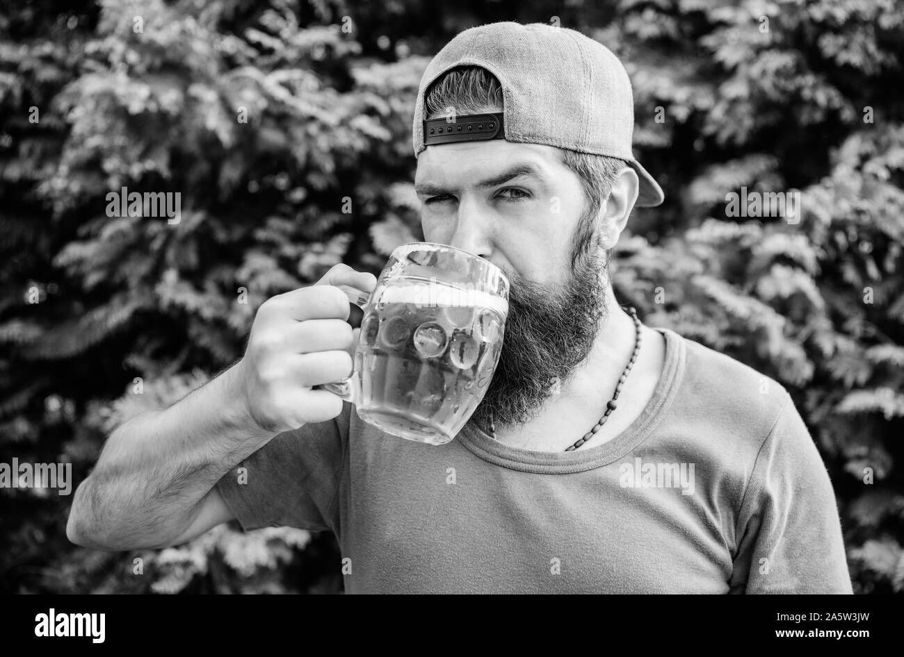 Preferring alcohol free beer. Drinker having refreshing alcoholic drink or refresher. Alcohol addict on summer nature. Suffering from alcohol addiction and bad habits. Controling his alcohol abuse. Stock Photo