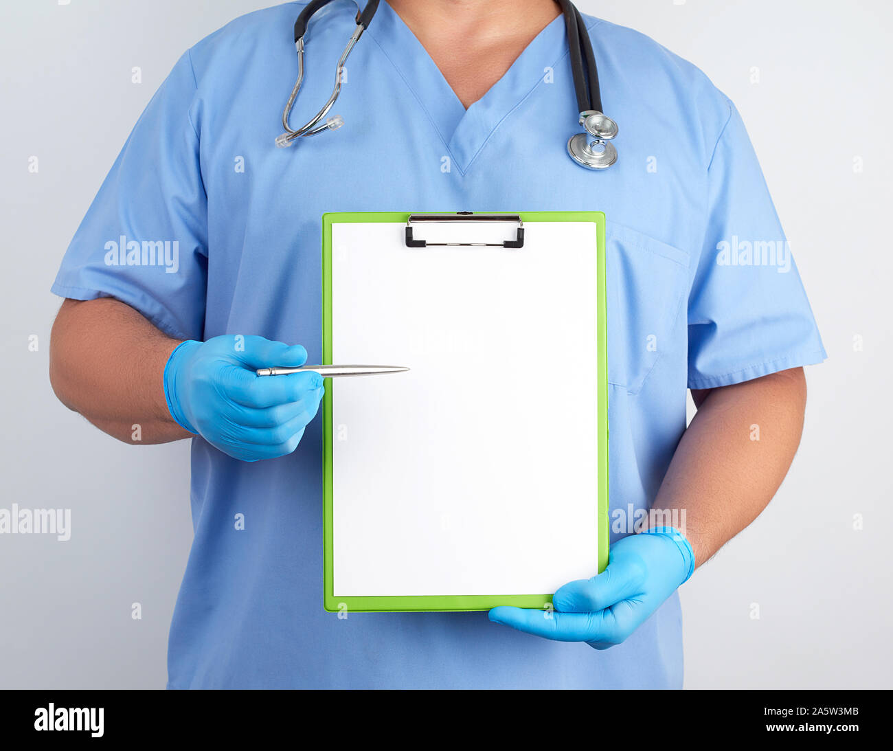 doctor in blue uniform and latex gloves holds a green holder for sheets ...