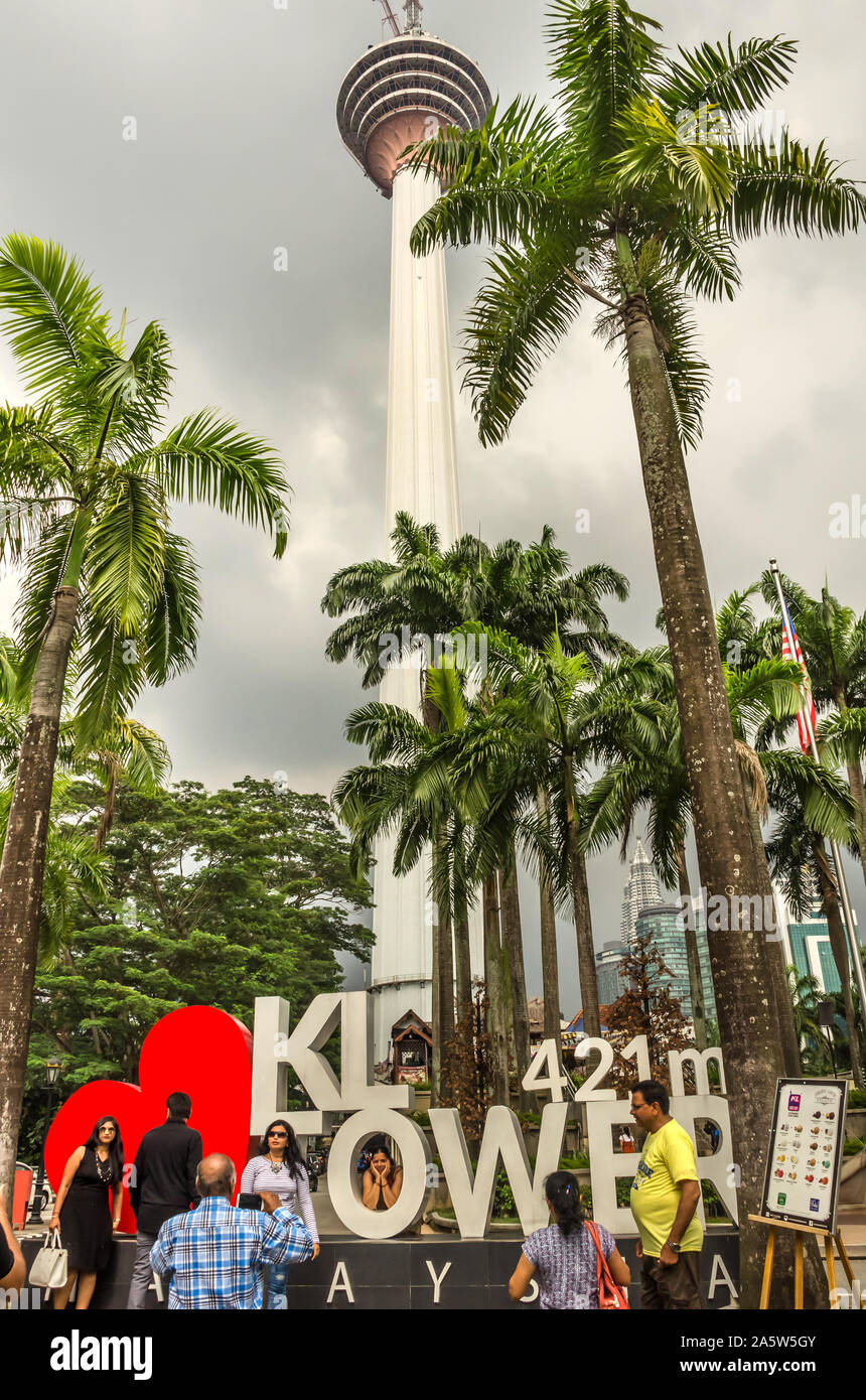 KUALA LAMPUR, MALAYSIA - DECEMBER 19, 2018: Tourists in front of KL Tower or Menara Kuala Lumpur is a telecommunication tower and tourist attraction. Stock Photo