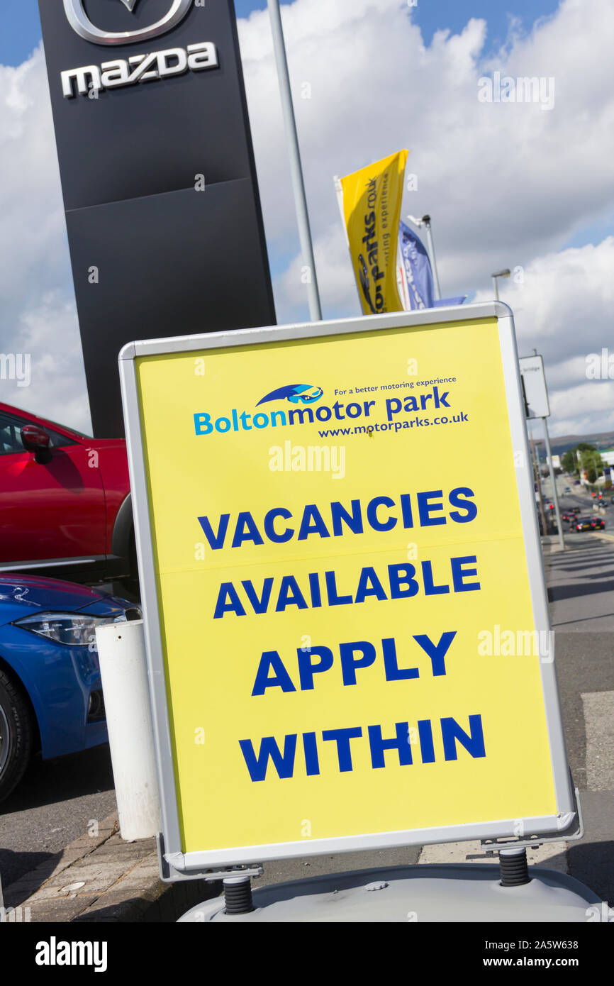 Car showroom employment vacancies being advertised outside a car dealer premises at BoltonMotor Park, Manchester Road, Bolton. Stock Photo