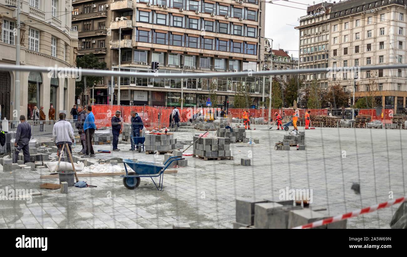 Belgrade, Serbia, Oct 7, 2019 - Construction workers paving the Republic Square (Trg republike) in pedestrian city zone Stock Photo