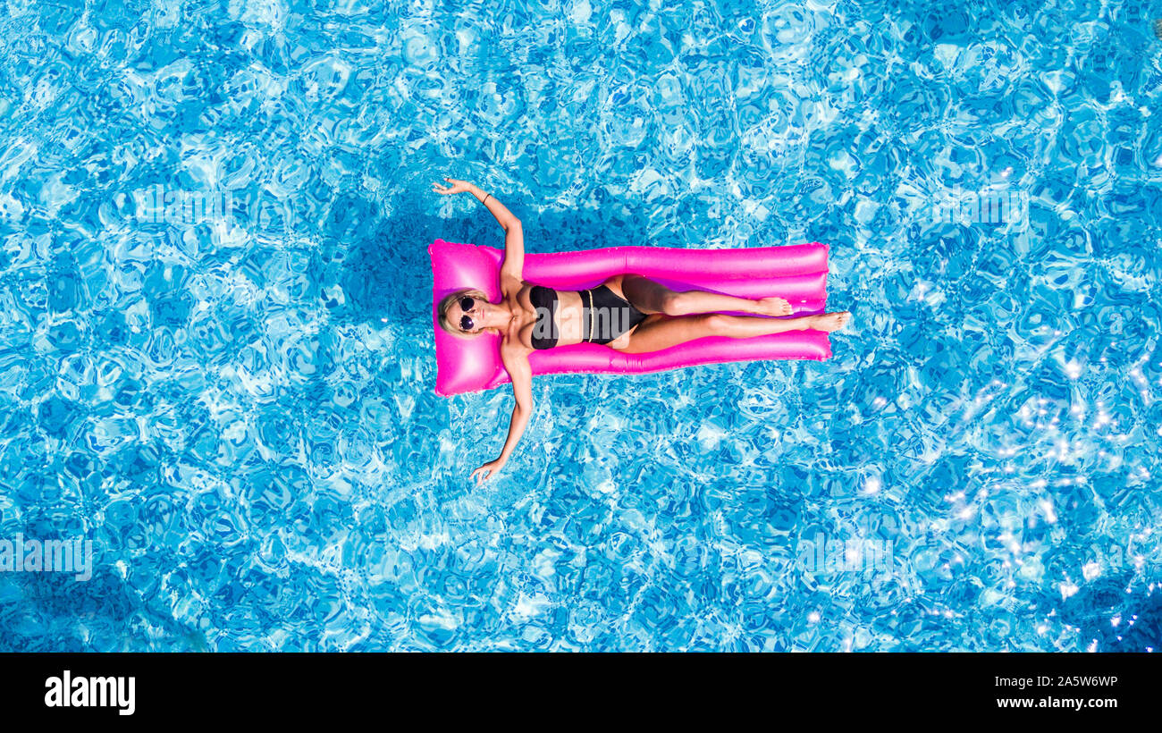 Slim young woman lying on air mattress in the pool Stock Photo Alamy