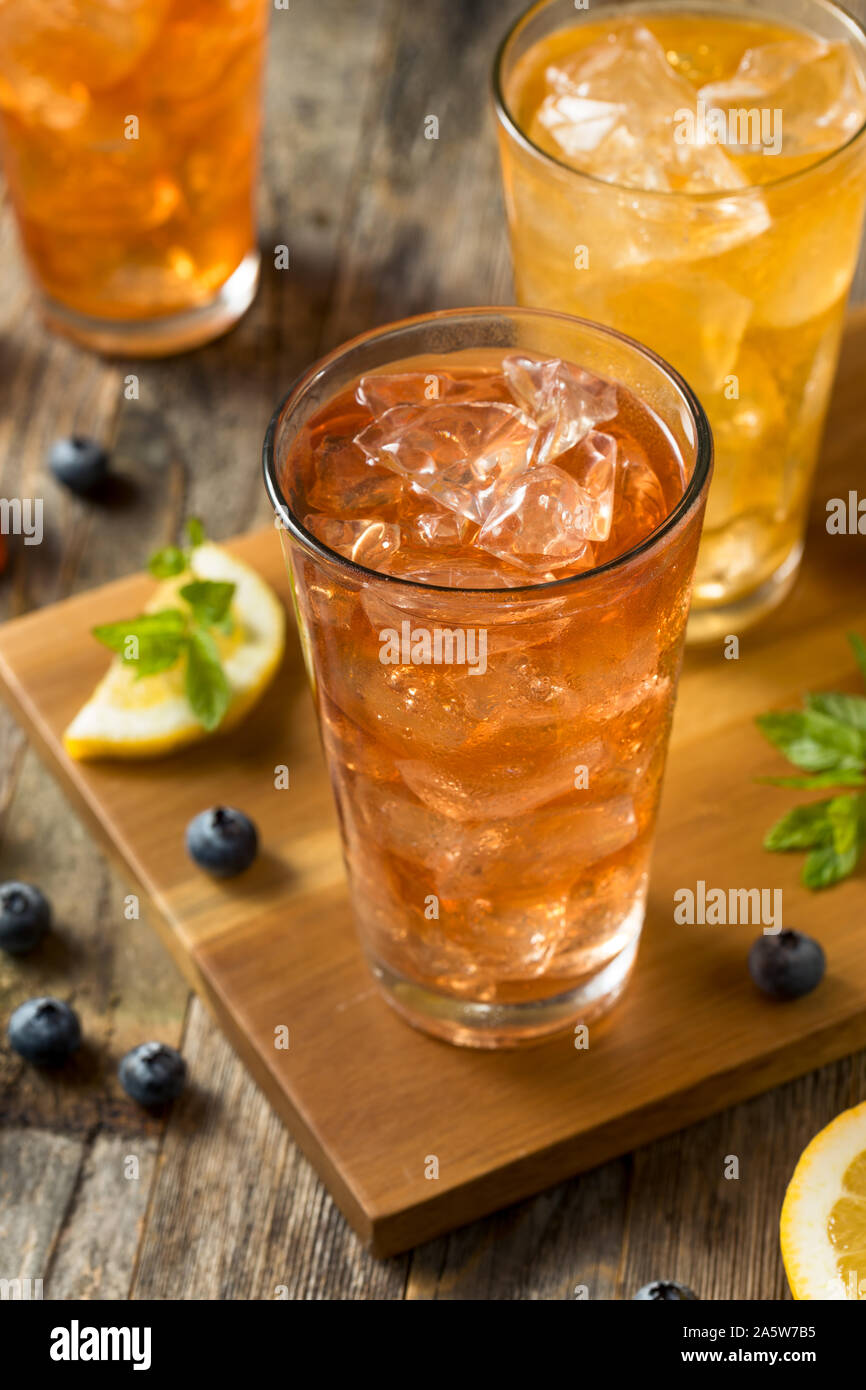 Cool Refreshing Flavored Berry Iced Teas with Lemon and Mint Stock Photo
