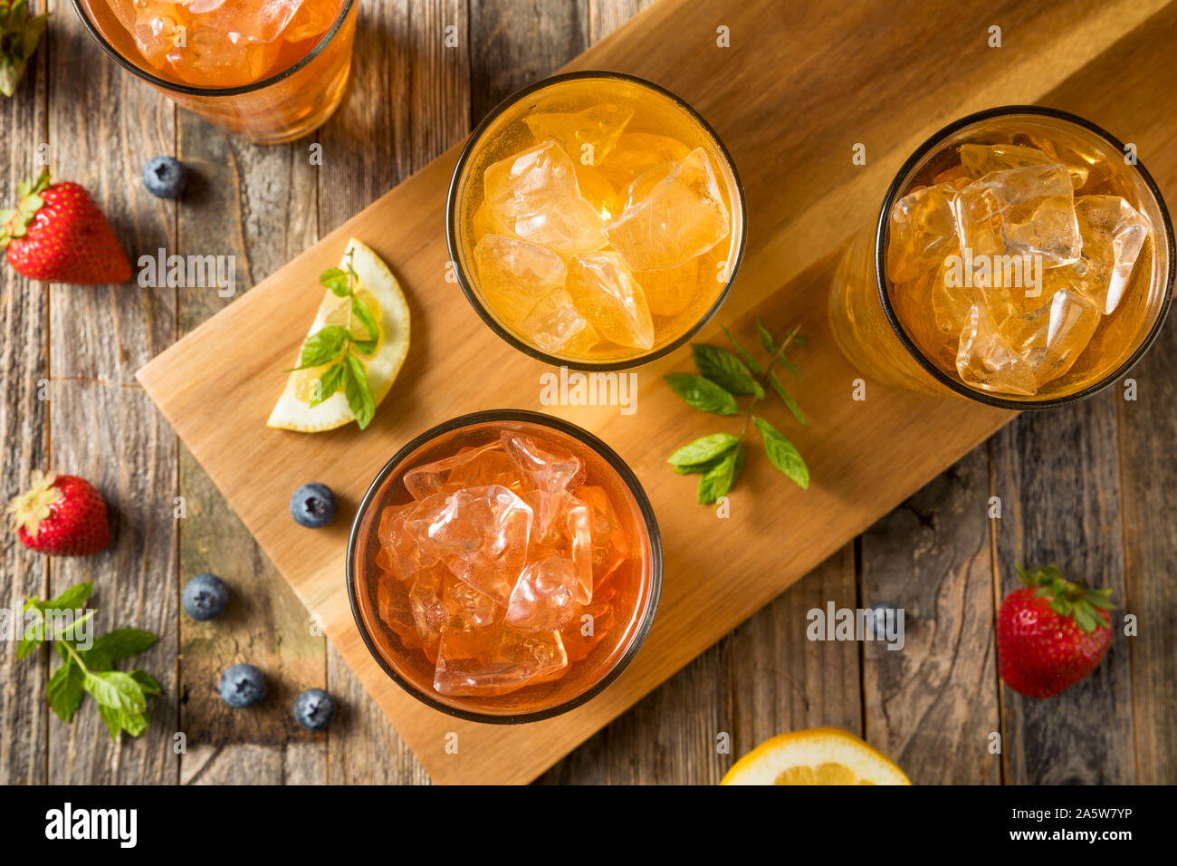 Cool Refreshing Flavored Berry Iced Teas with Lemon and Mint Stock Photo