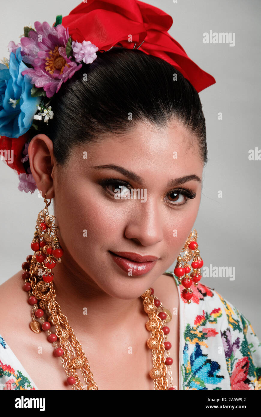 Portrait of a younf mexican girl in full mayan huipil traditional attire. Stock Photo