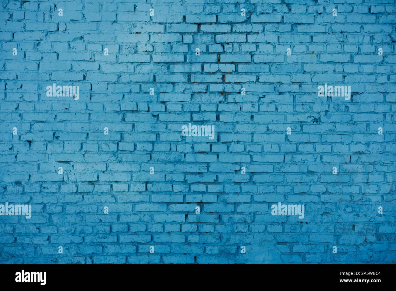 old red brick Brick wall painted with deep blue paint Stock Photo