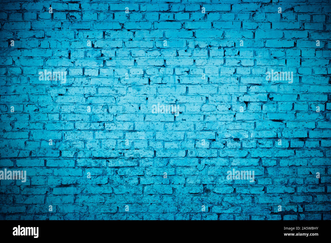 old red brick Brick wall painted with deep blue paint Stock Photo