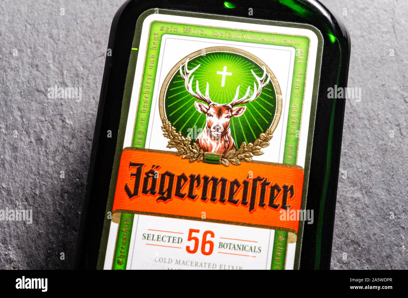 Jagermeister digestif on stone slate background. Jagermeister made with 56 herbs and spices. It is manufactured by Mast-Jagermeister SE, Germany Stock Photo