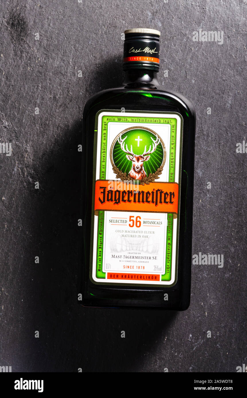 Jagermeister digestif on stone slate background. Jagermeister made with 56 herbs and spices. It is manufactured by Mast-Jagermeister SE, Germany Stock Photo
