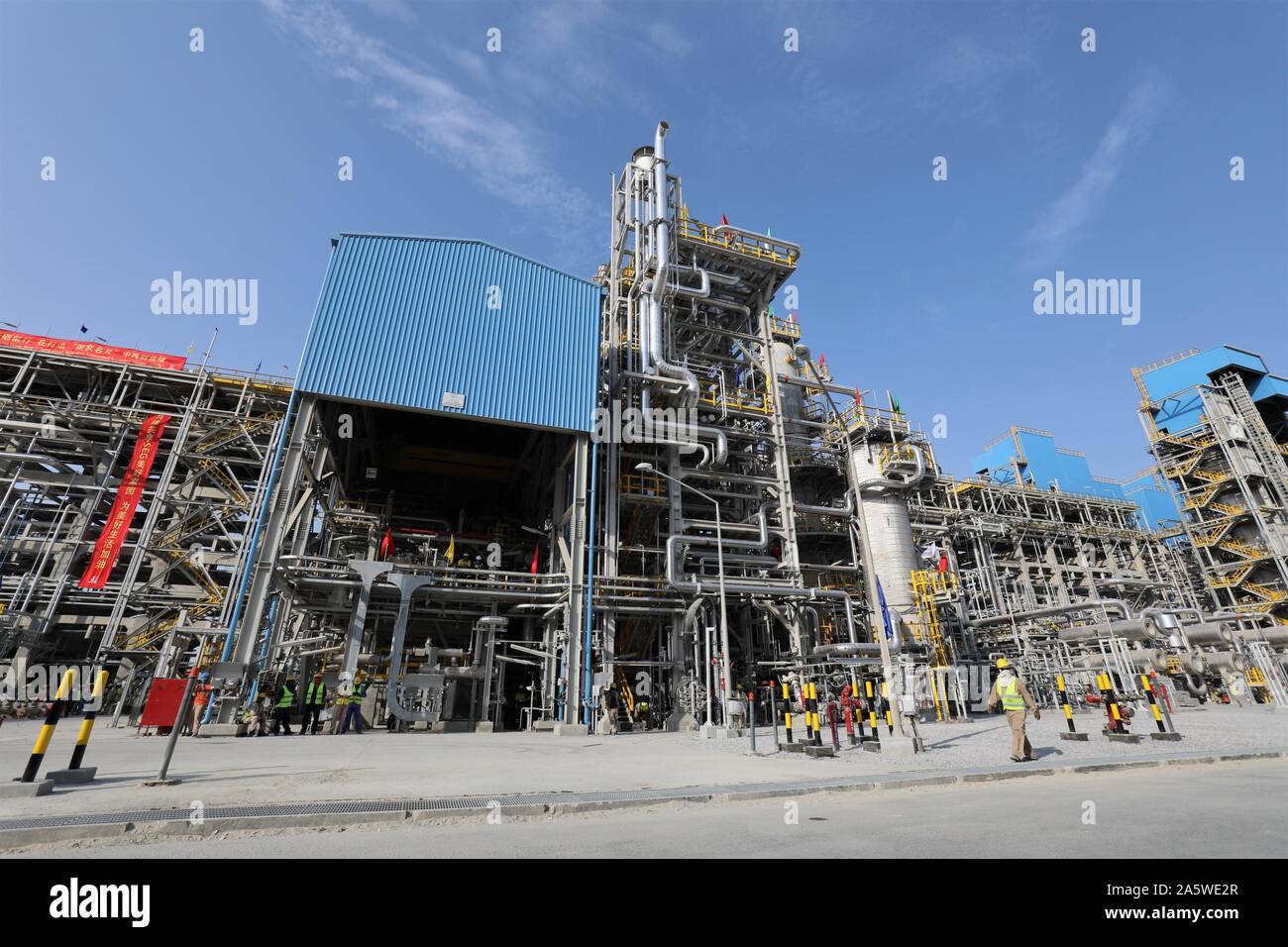 Al Ahmadi, Kuwait. 22nd Oct, 2019. Workers walk on the construction
