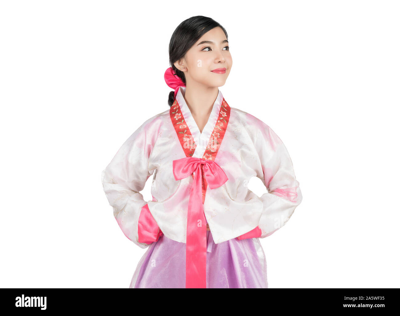 Portrait of young attractive Korean Woman with Hanbok, the traditional Korean dress smiling with white background with clipping path feeling confident Stock Photo