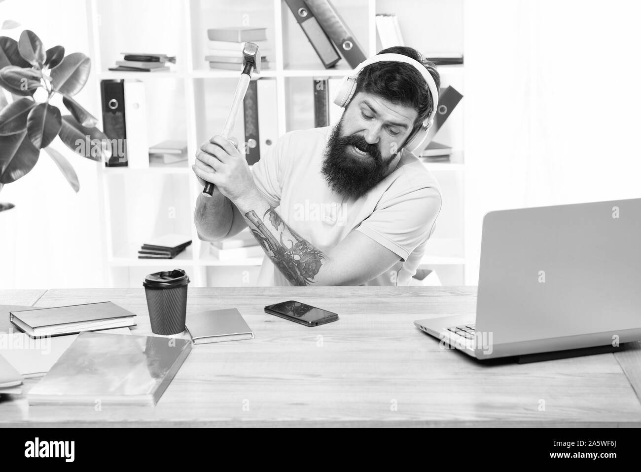 Failed mobile negotiations. Most annoying thing about work in call center. Incoming call. Annoying client calling. Man bearded guy headphones office swing hammer on smartphone. Spoiled communication. Stock Photo