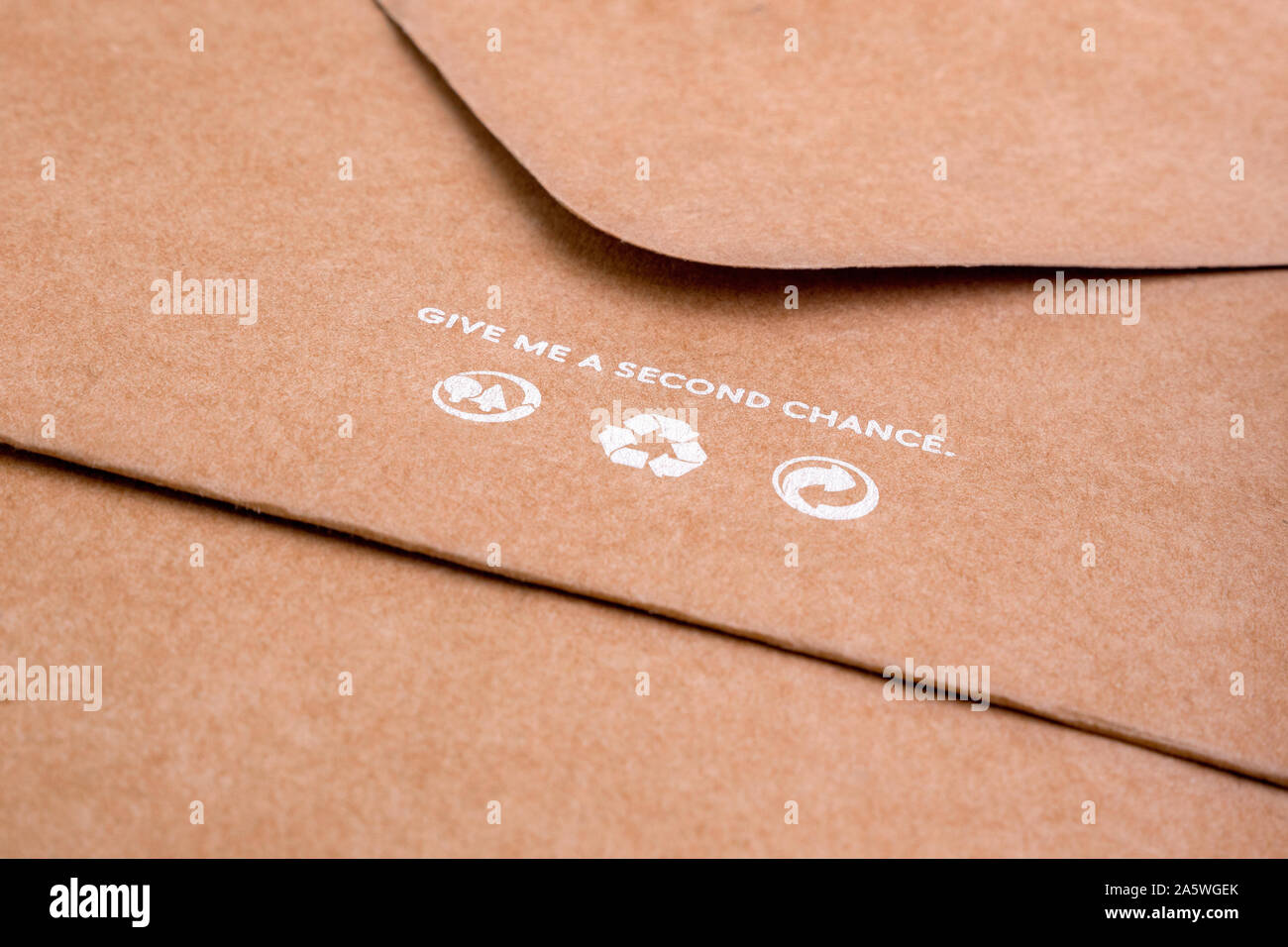 Brown envelope with recycling icons on it. Craft paper for packaging. SAVE PLANET concept. Life standarts concept. Stock Photo