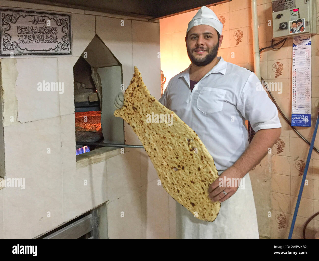 Iranian baker displayed a large fresh baked Naan to customers Stock
