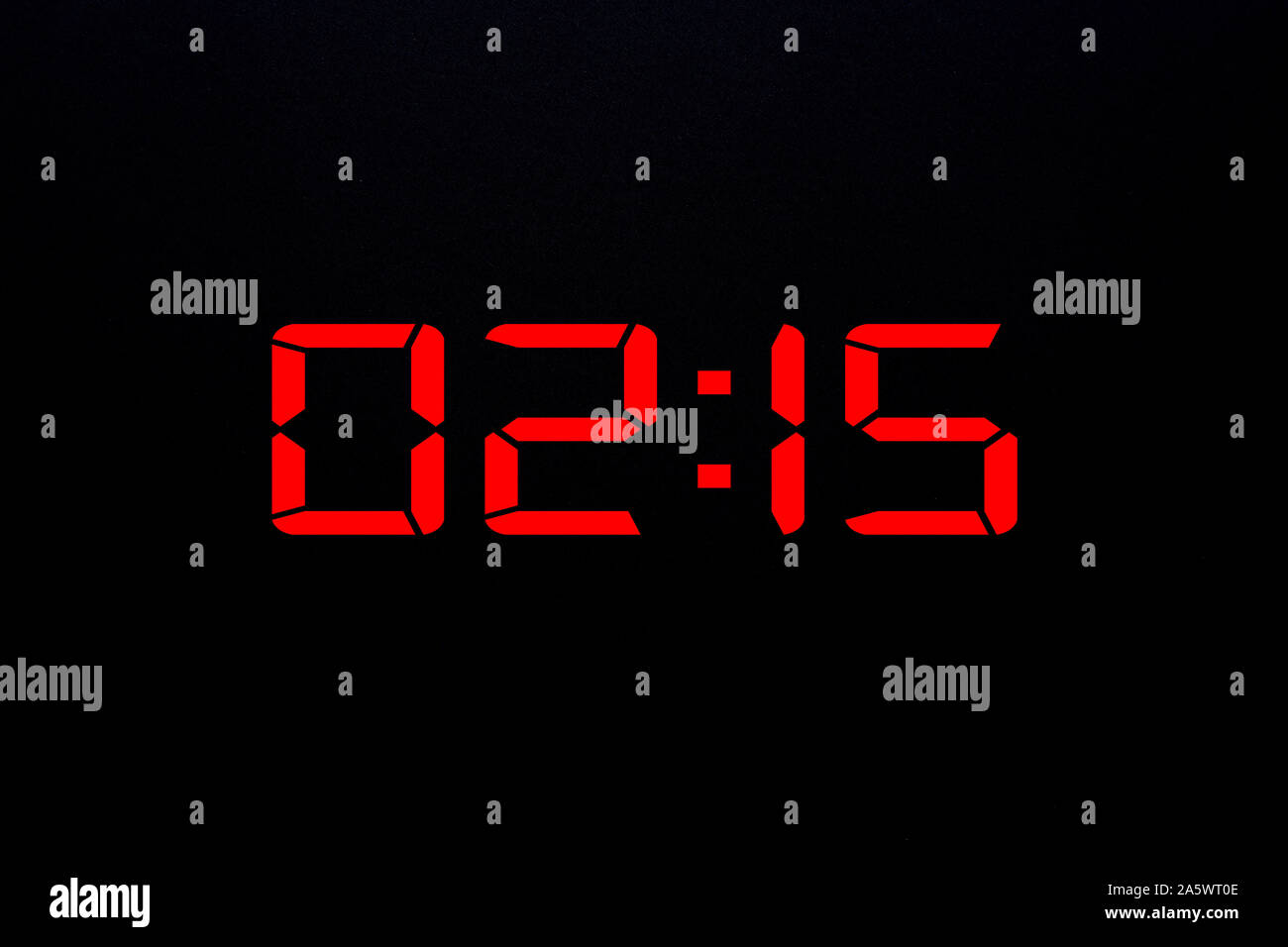 Showing time 02:15 on red led digital clock isolated black background Stock Photo