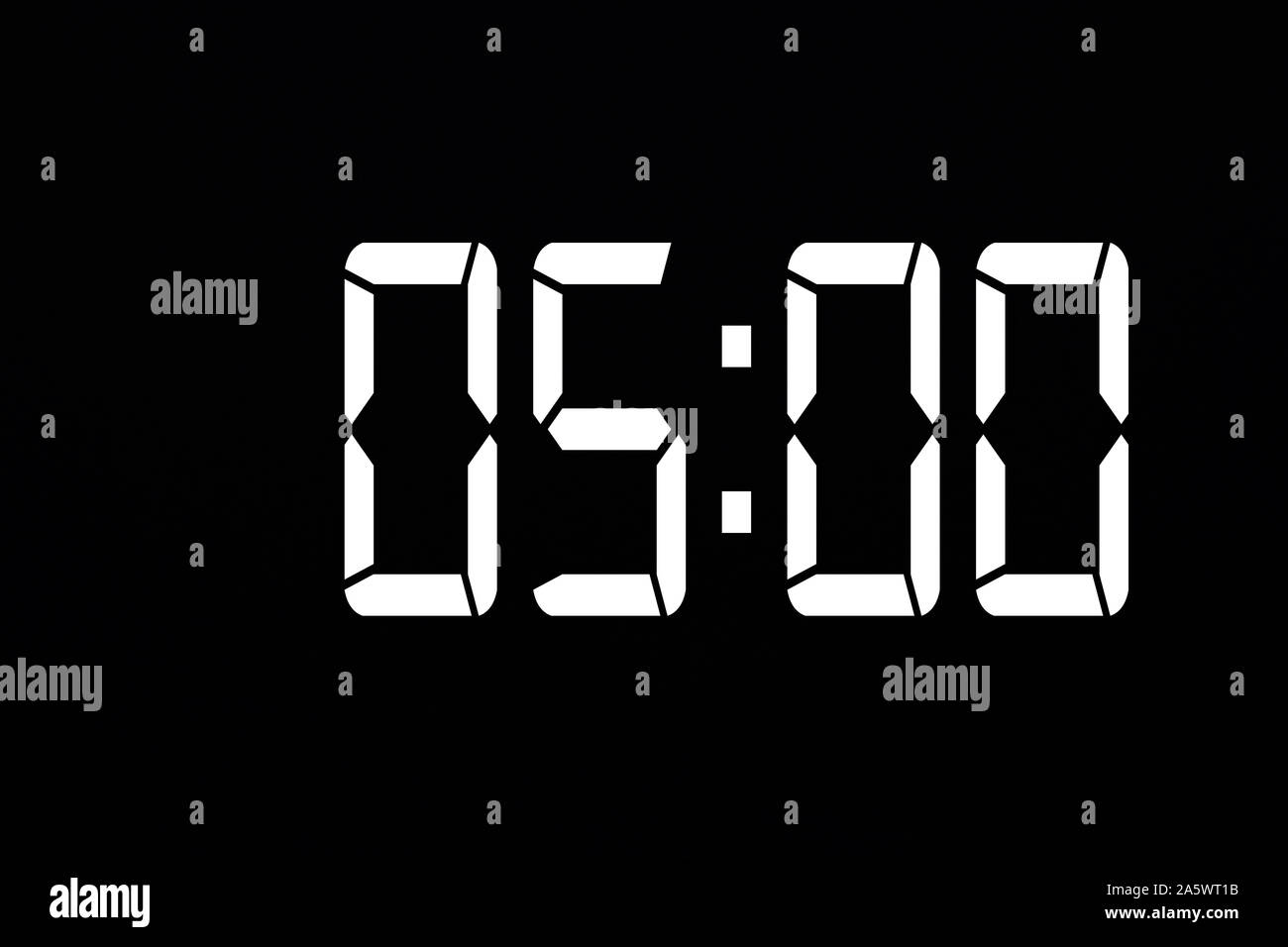 Showing time 05:00 on white led digital clock isolated black background Stock Photo