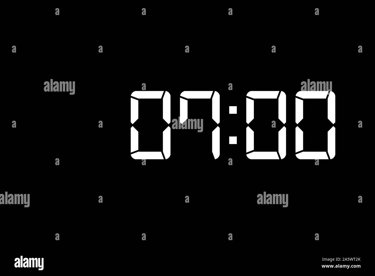Showing time 07:00 on white led digital clock isolated black background Stock Photo