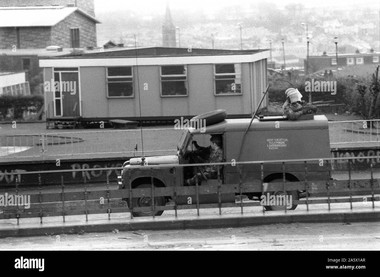 The Troubles 1980s Derry Northern Ireland Londonderry 1983 British soldiers on patrol in armoured vehicle 80s HOMER SYKES Stock Photo