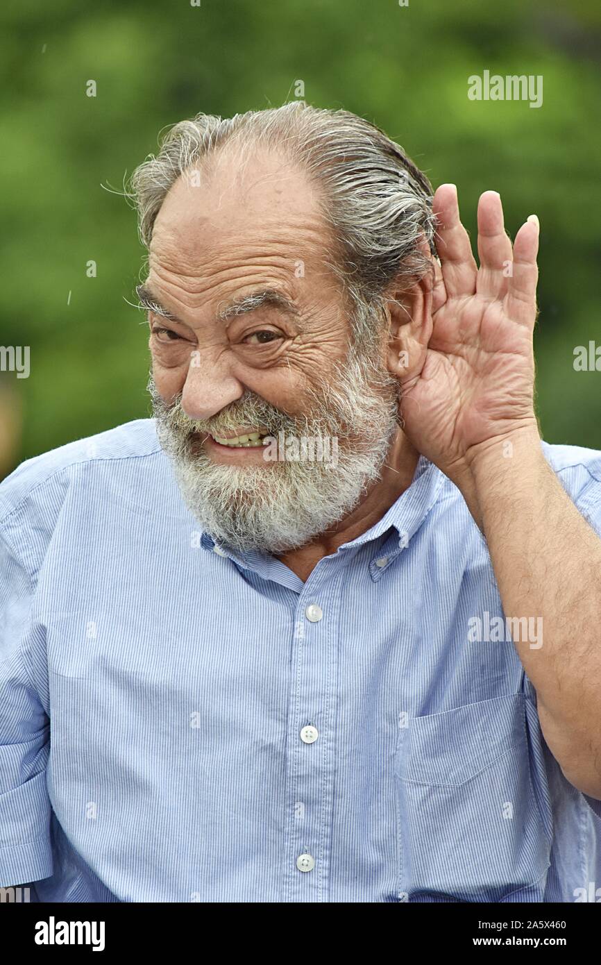 An Old Grandpa Listening Stock Photo