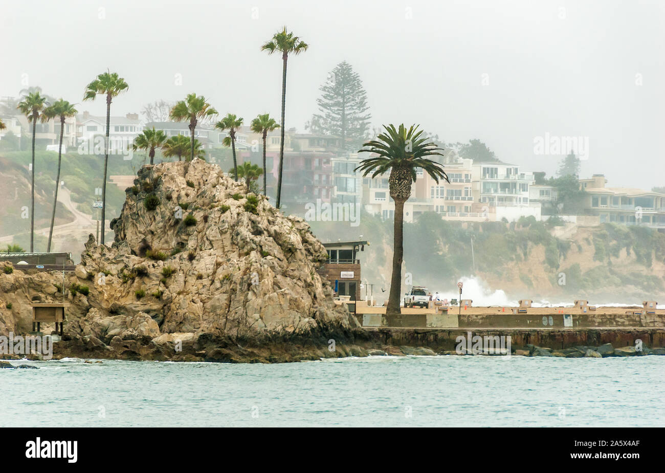 View of Corona del Mar in Newport Beach, California across the Newport Harbor Channel from The Wedge, a world famous surf spot on Balboa Island. (USA) Stock Photo