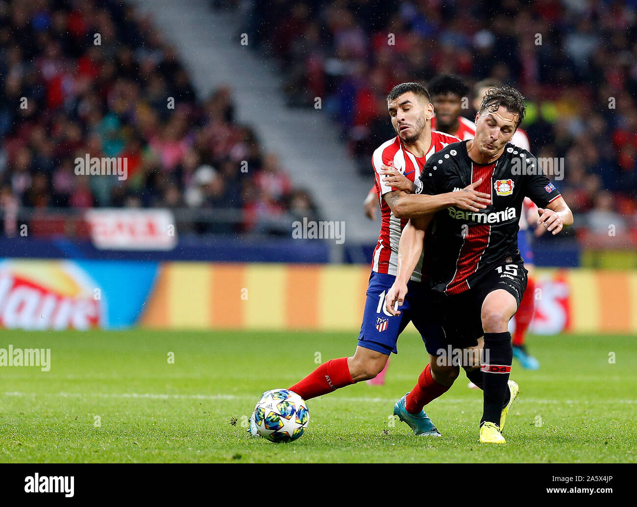 Madrid, Spain. 22nd Oct, 2019. Atletico de Madrid's Angel Correa and Bayern 04 Leverkusen's Julian Baumgartlinger are seen in action during the UEFA Champions League match between Atletico de Madrid and Bayern 04 Leverkusen at the Wanda Metropolitano in Madrid.(Final score; Atletico de Madrid 1:0 Bayern 04 Leverkusen) Credit: SOPA Images Limited/Alamy Live News Stock Photo