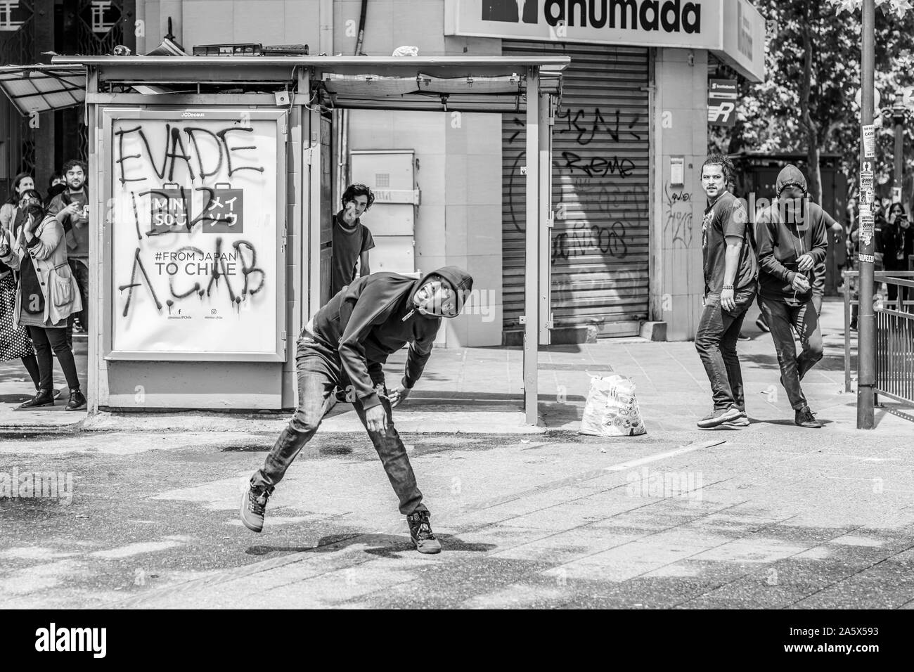 Clashes between the police and protesters at Santiago city streets during the latest riots of October 2019 in the Chilean country Stock Photo