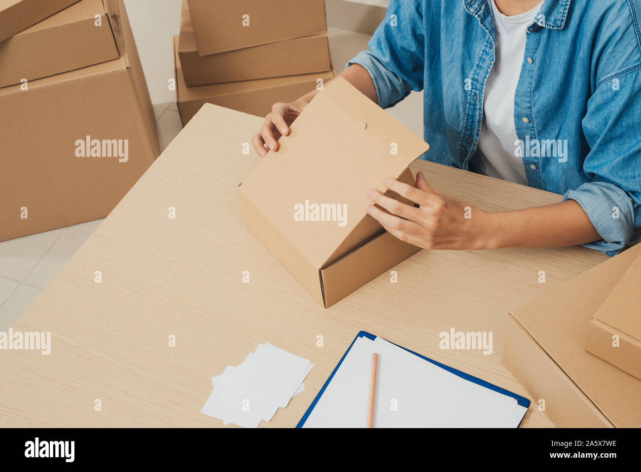 Young startup entrepreneur small business owner working at home, packaging and delivery situation. Stock Photo