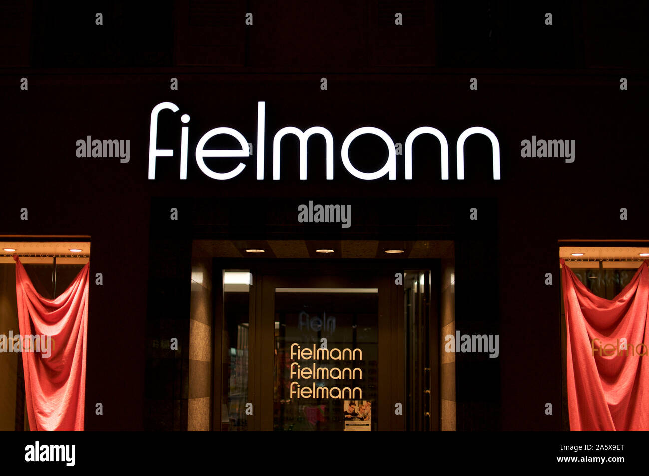 Lugano, Ticino, Switzerland - 12th July 2019 : Night view of the Fielmann store entrance in the city of Lugano. Fielmann is a german eye-wear company Stock Photo
