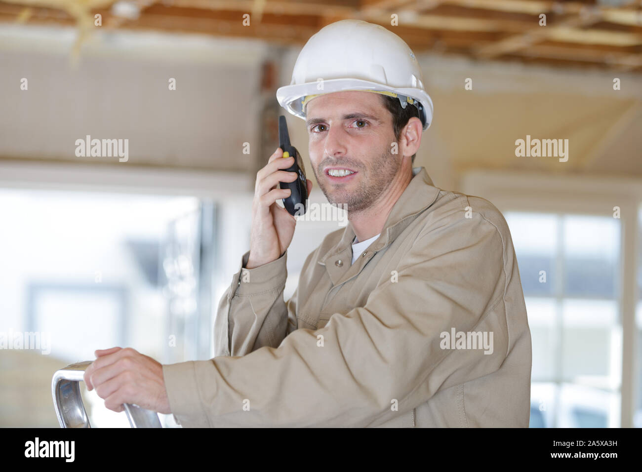 foreman on site using walkie talkie Stock Photo