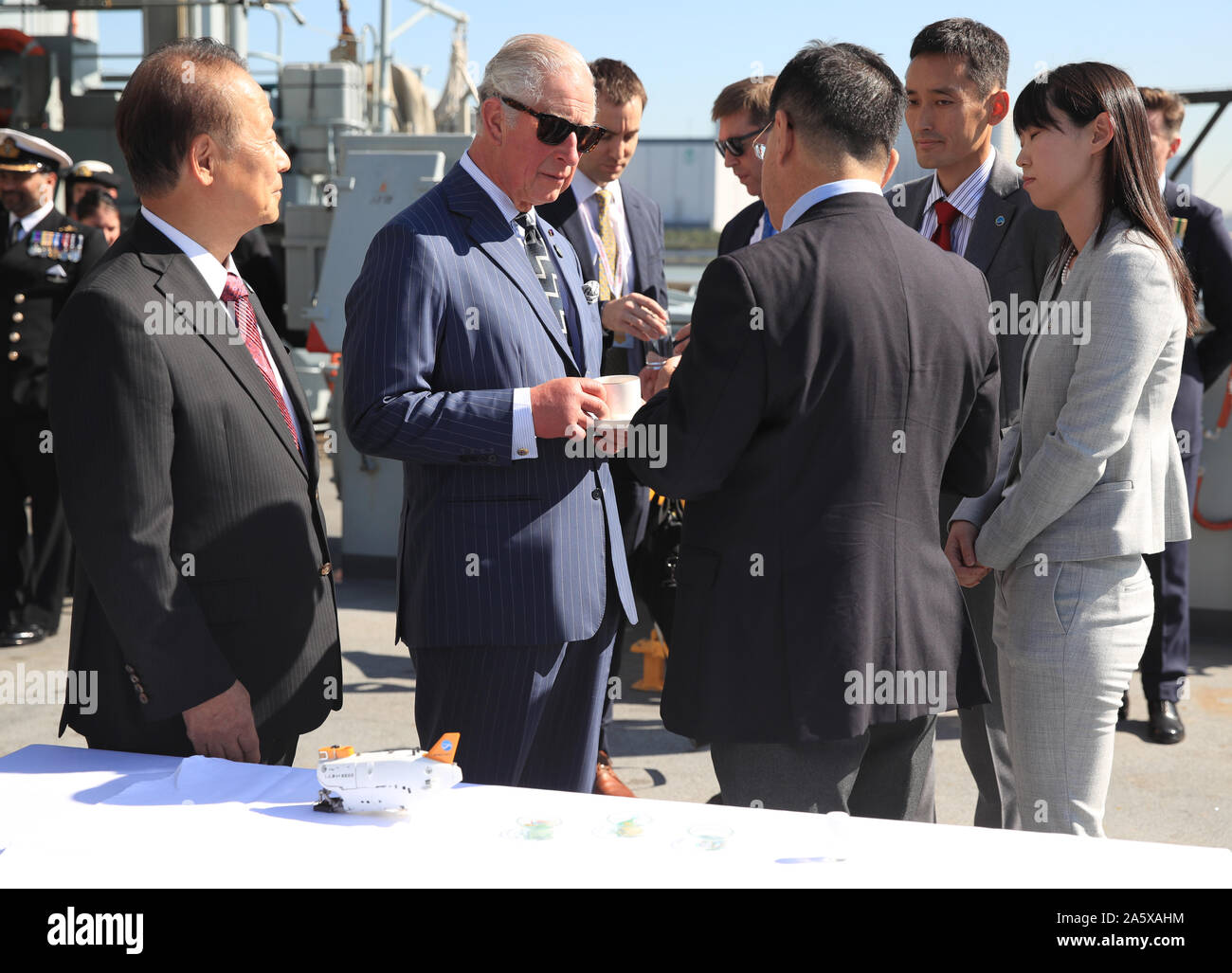 The Prince of Wales meets with representatives of groups tackling ocean plastics and climate change during a visit to HMS Enterprise, which is moored at Harumi Pier in Tokyo, Japan. Stock Photo