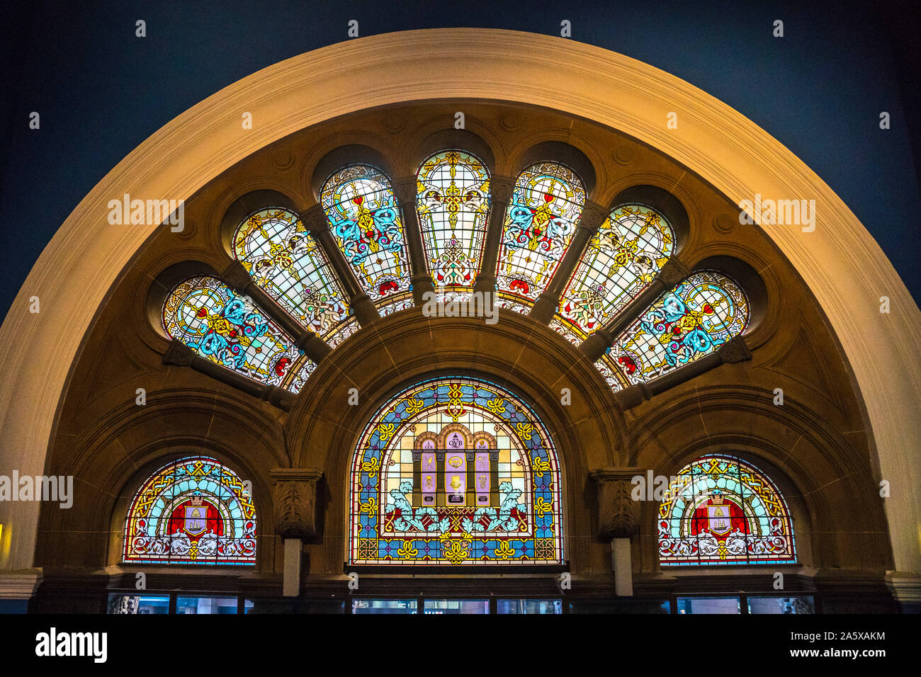 Stained glass panels above one of many entrances in Queen Victoria