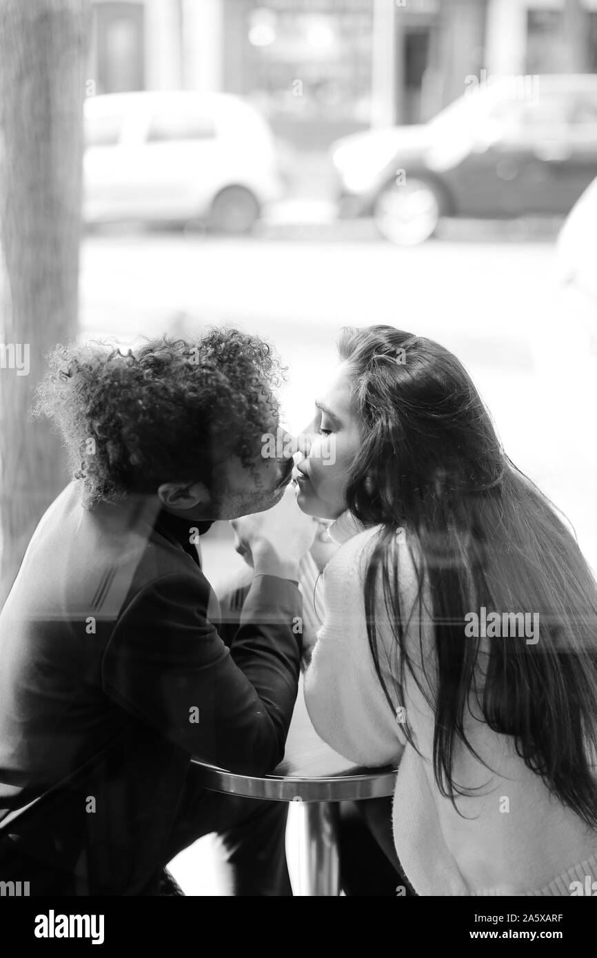 Black and white photo of afro american man kissing caucasian girl,  reflection in glass Stock Photo - Alamy