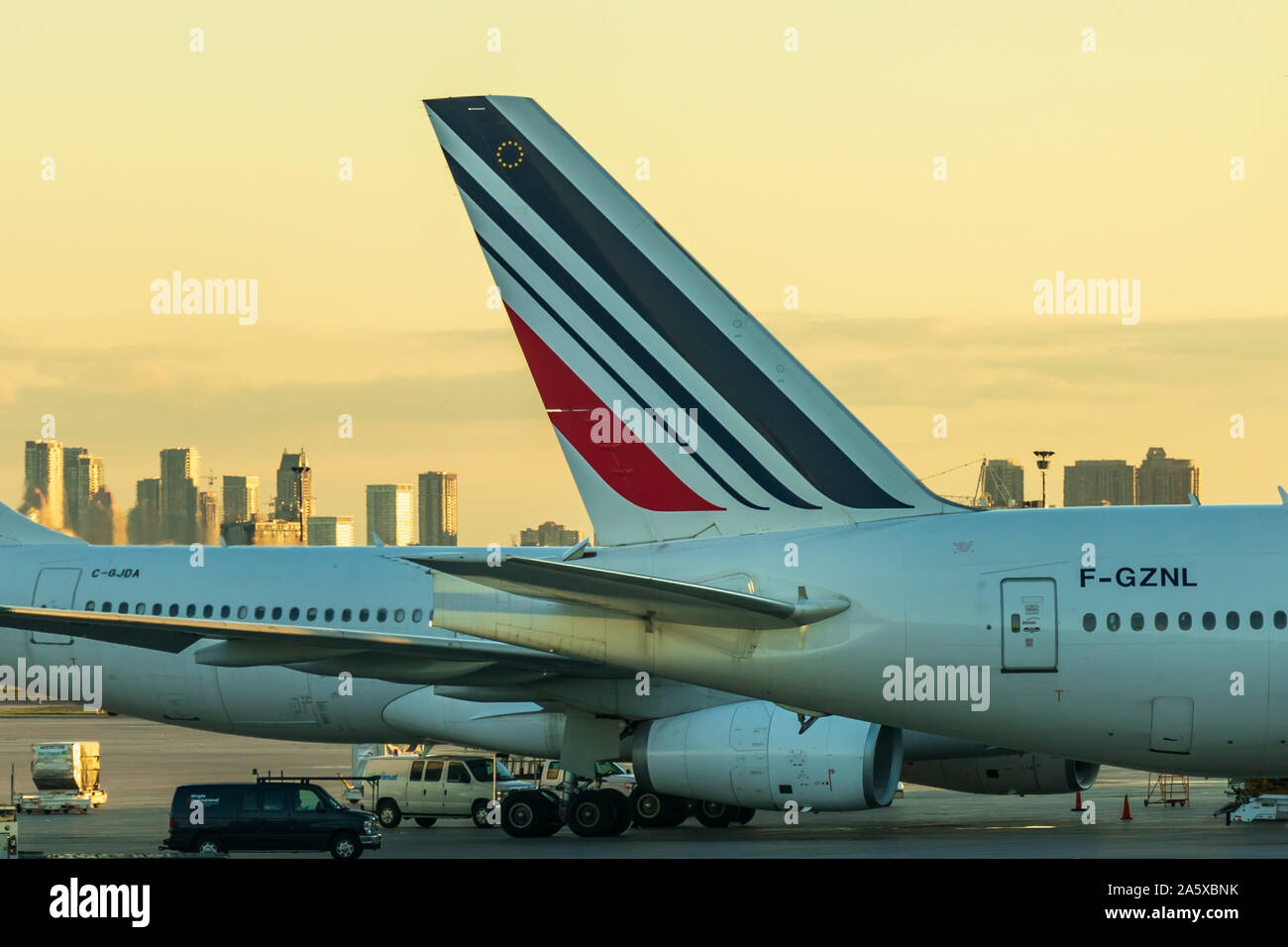 Tail of Air France Boeing 777-3 (F-GZNL) while at a gate during sunset at Toronto Pearson Intl. Airport. Stock Photo