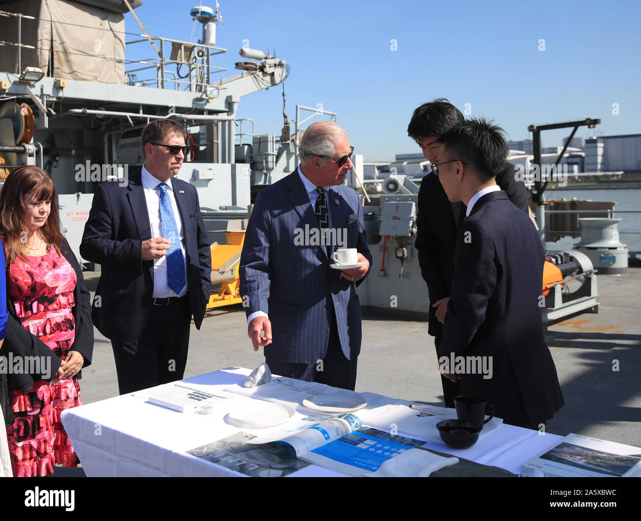 The Prince of Wales talks with representatives of groups tackling ocean plastics and climate change during a visit to HMS Enterprise, which is moored at Harumi Pier in Tokyo, Japan. Stock Photo