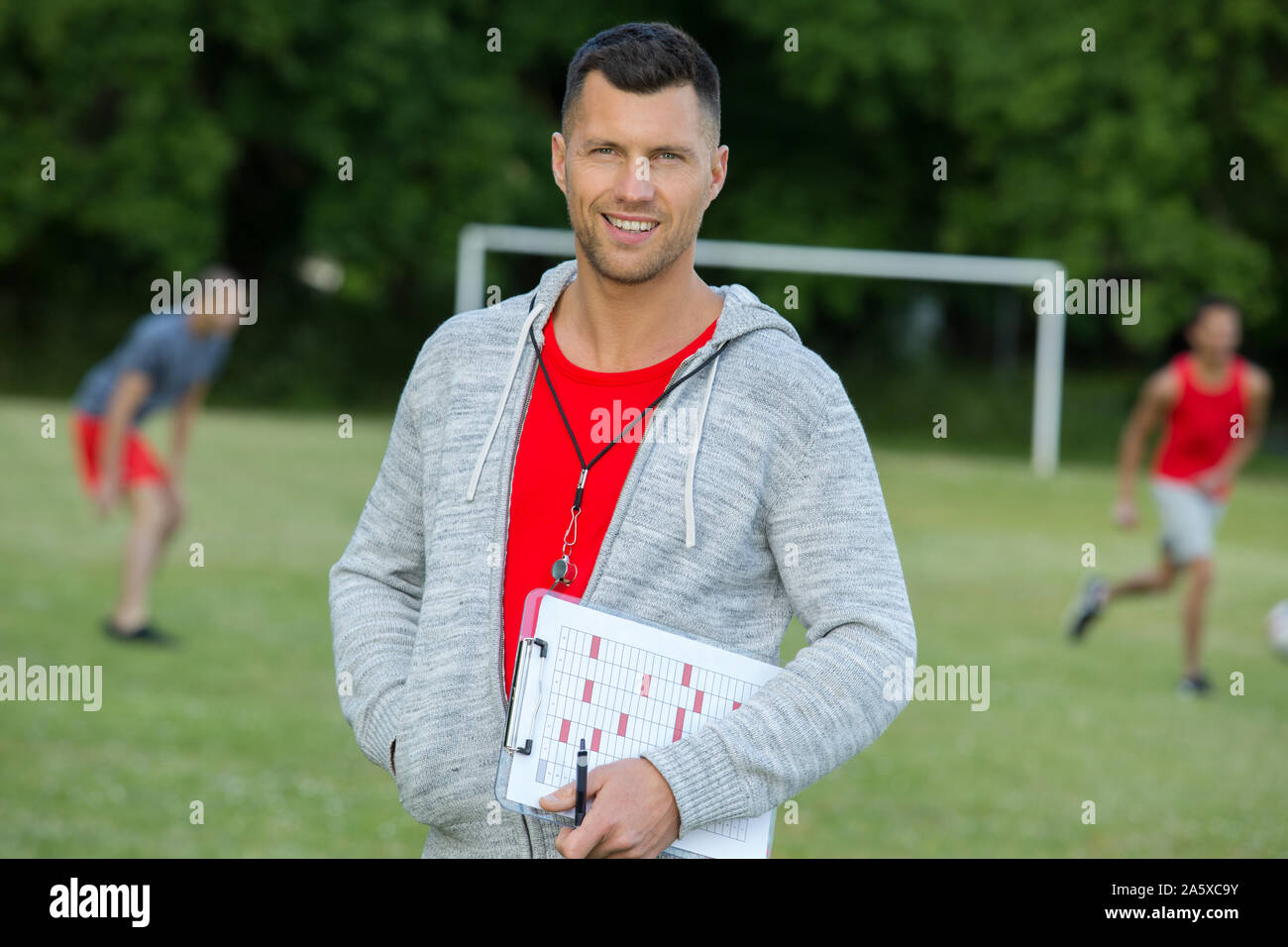 football coach posing during practice Stock Photo Alamy