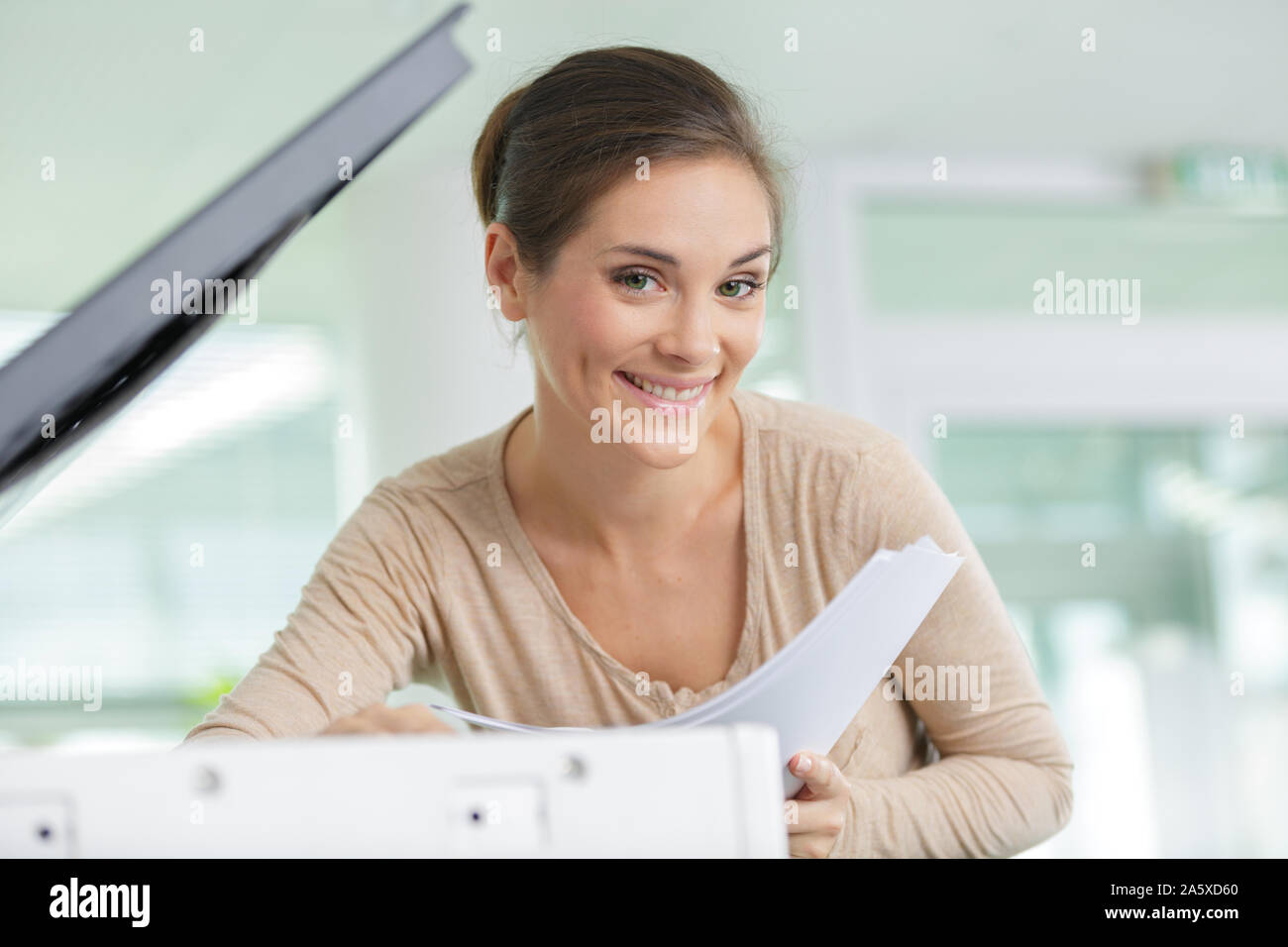 portrait of a beautiful woman by the photocopier Stock Photo Alamy