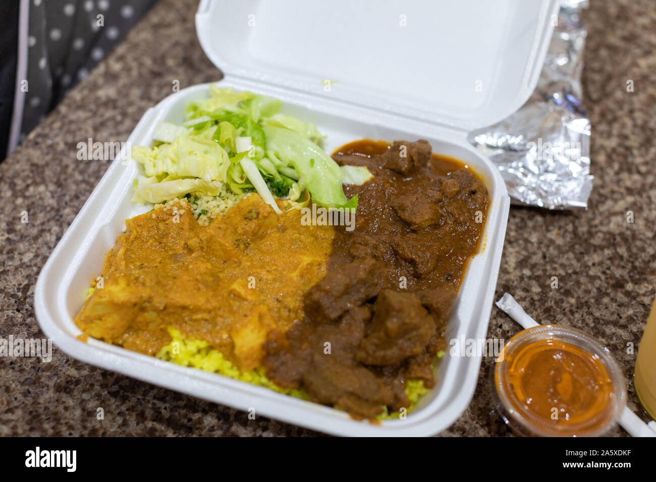 Takeaway Curry - Chicken curry and ramp curry with yellow rice in a white  plastic container Stock Photo - Alamy