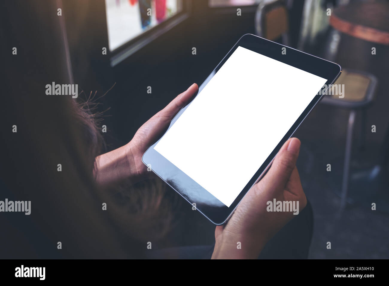 Mockup image of woman's hands holding black tablet pc with blank white ...