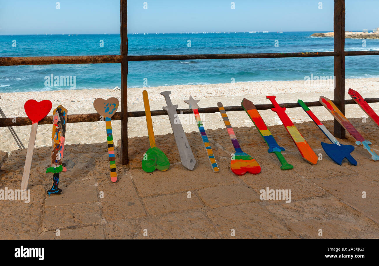 multi-colored children’s, wooden swords on a background of the sea Stock Photo
