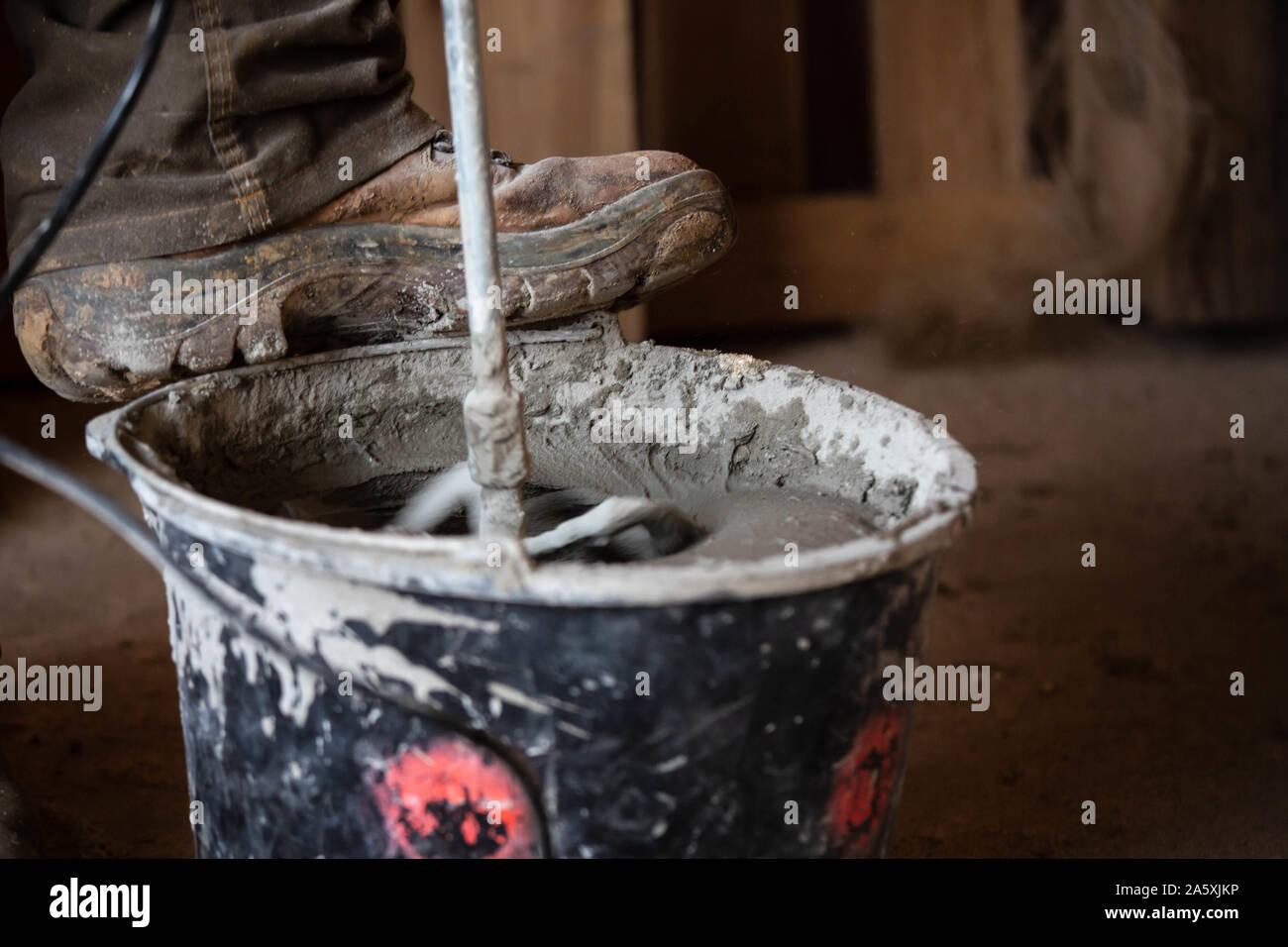 Man mixing cement in bucket Stock Photo Alamy