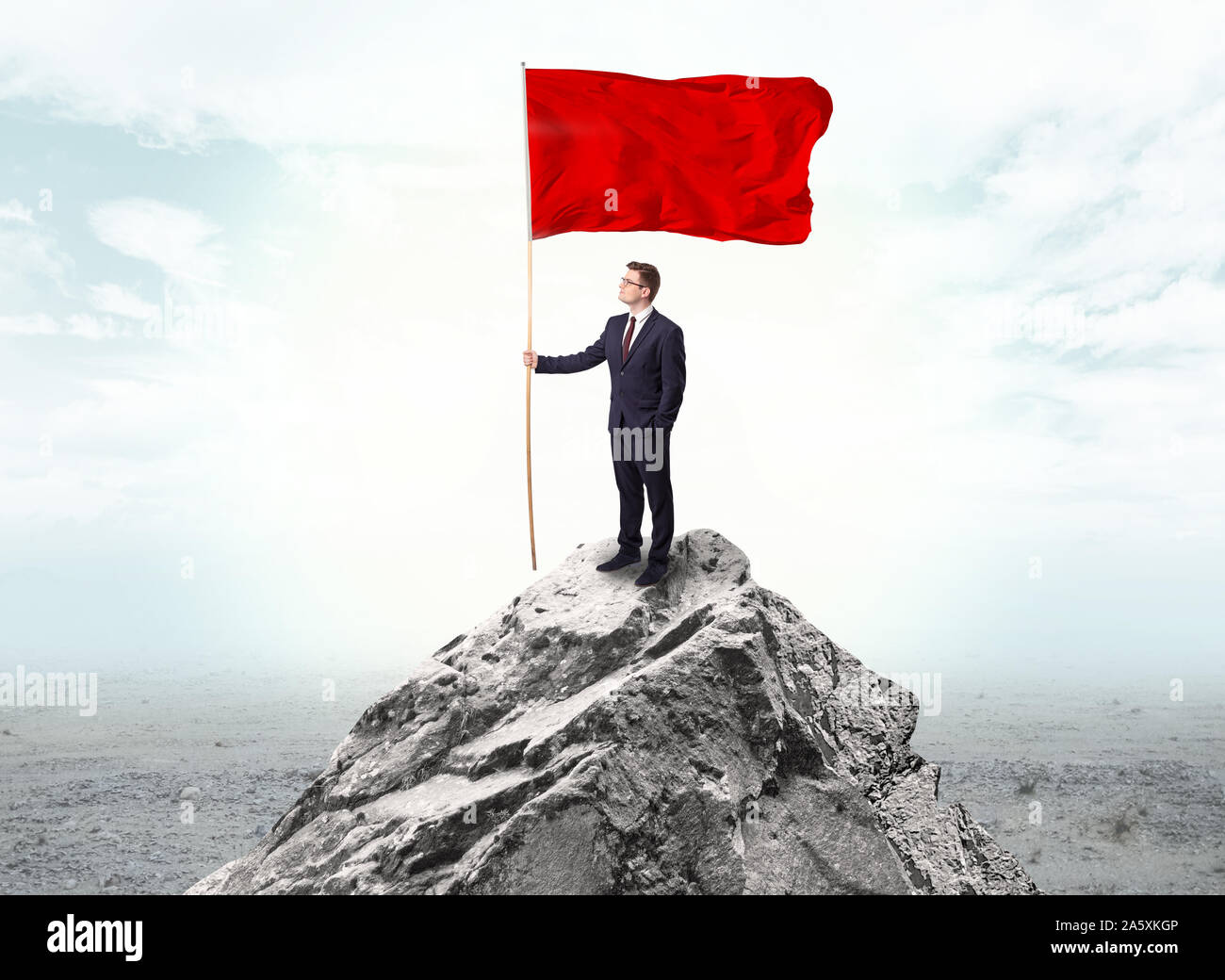 Handsome businessman on the top of the mountain with red flag Stock ...
