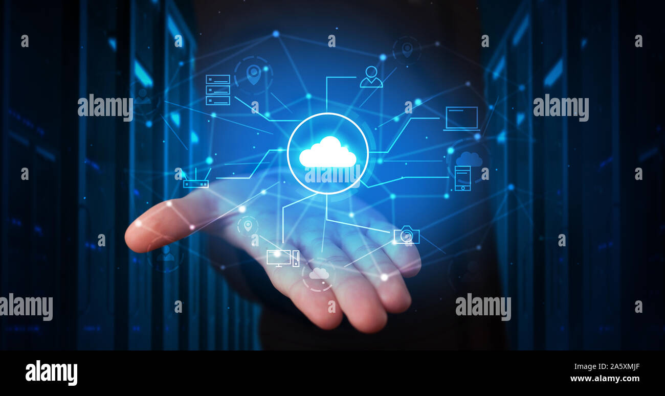 Man holding hologram projection displaying cloud technology symbols Stock Photo