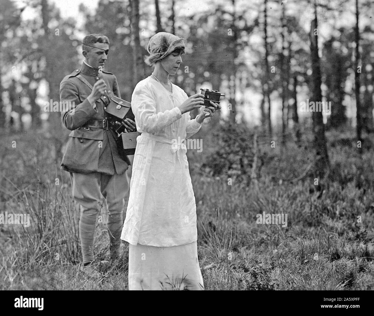 Queen Elizabeth of Belgium taking a picture on the battlefield at Ypres, Belgium ca. June 1919 Stock Photo