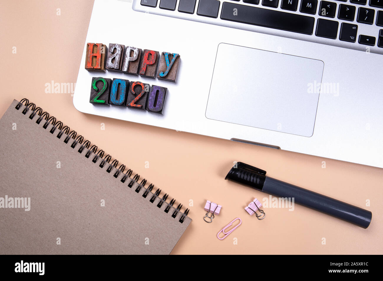 Happy 2020, words made from colorful wooden alphabet letters. Workplace