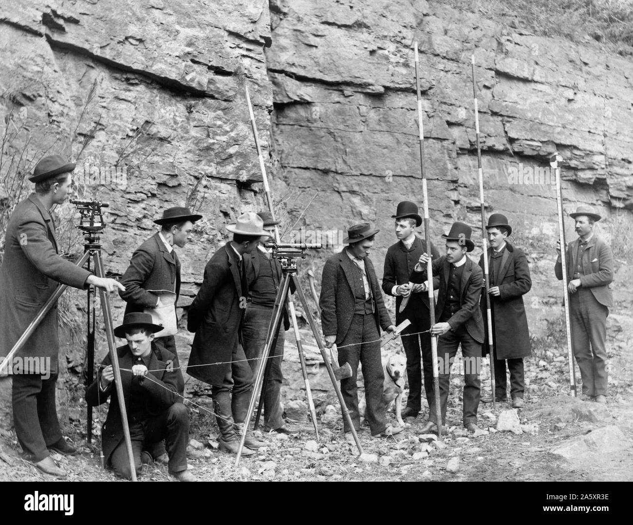 Outdoor group portrait of ten railroad engineers, wearing suits and