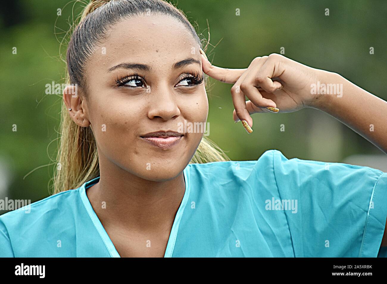 Hispanic Female Nurse Thinking Stock Photo